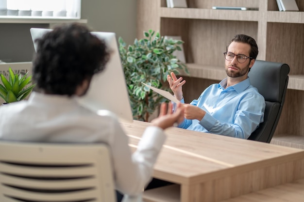 Two men in the office having a negotiations and looking involved