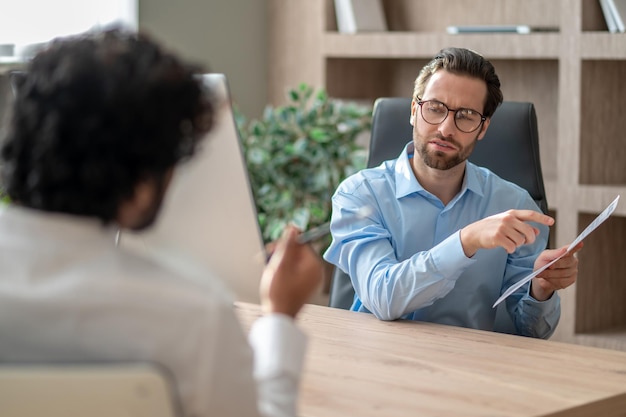 Two men in the office having a negotiations and looking involved