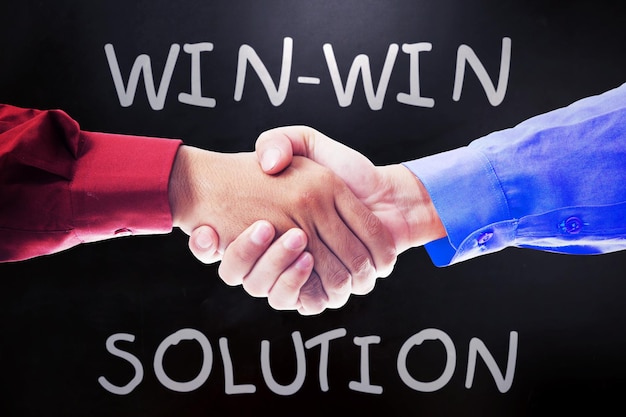 Two men shaking hands with winwin solution text
