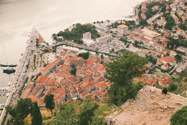 Two men on top of hill with view of kotor in montenegro