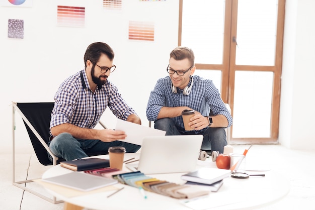 Two men work together in the office.