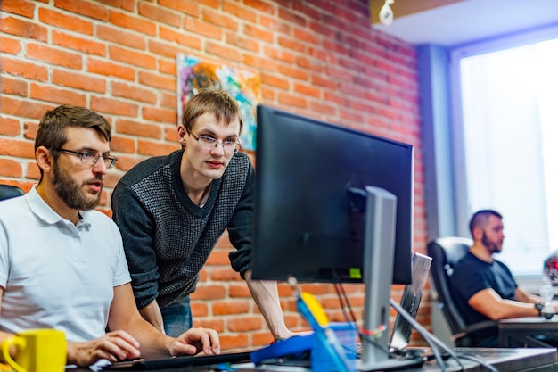 Two men working in a modern office Achieving the best results Two confident young men are discussing business plans