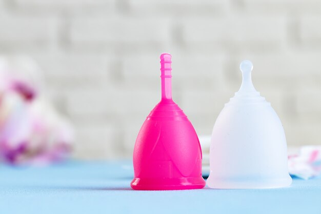 Two menstrual cups on table close up