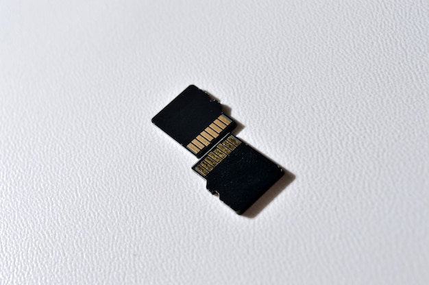 two micro sd cards on a white plastic background. close-up.