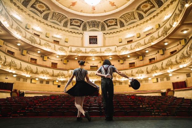 Two mime artist bowing on stage in auditorium