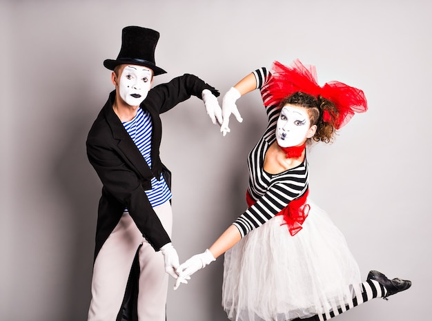 Two mimes shows the heart. Pantomime heart, love concept, April Fools Day concept.