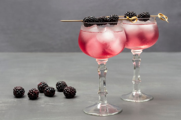 Two misted wine glasses with cooling drink and ice