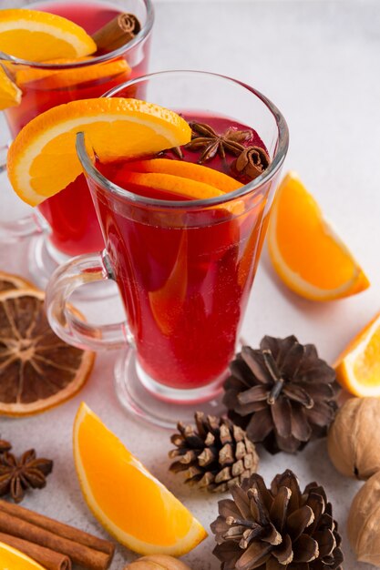 Two mugs of mulled wine. Ingredients for a cocktail. Hot winter drinks based on sparkling wine.