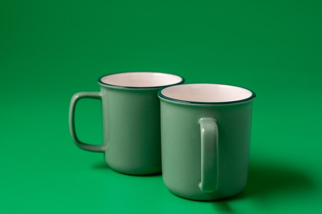 Two mugs of neo mint color on green