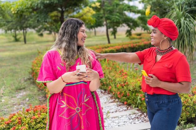 Two multiethnic girls talk in city park