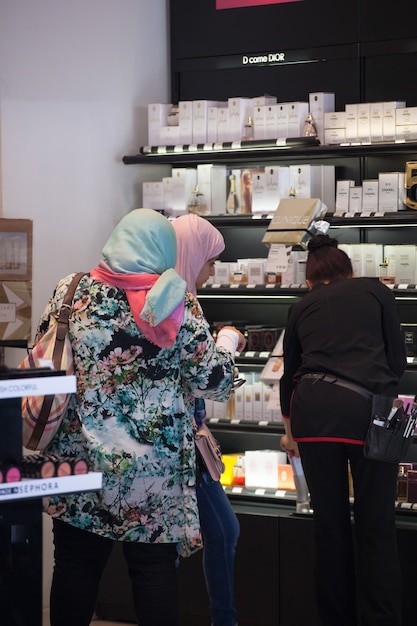 Two muslim woman in the perfumes sho