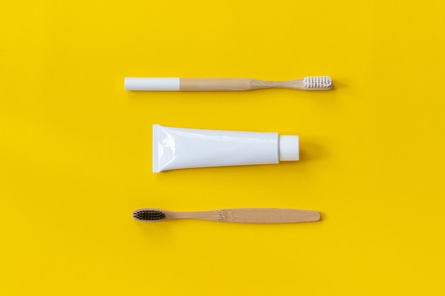 Two natural eco-friendly bamboo brushes and tube of toothpaste. set for washing