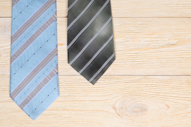 Two neckties on white wooden table