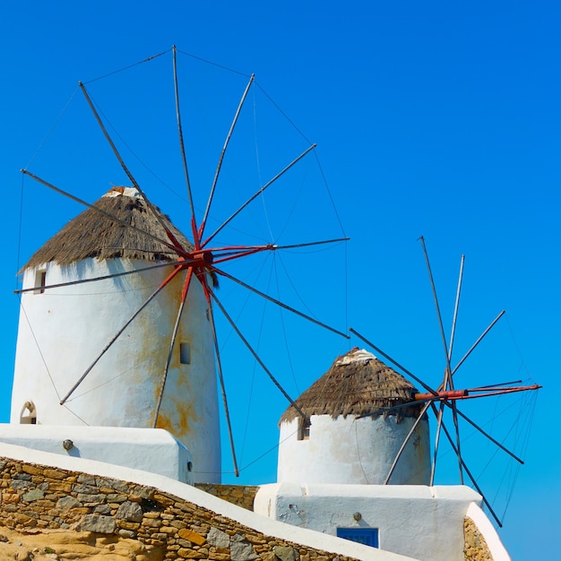 Two old white windmillls in Mykonos island in Greece