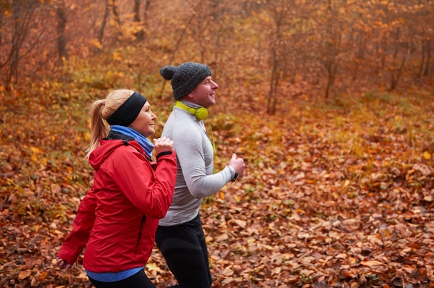 Two older people jogging in the pathway