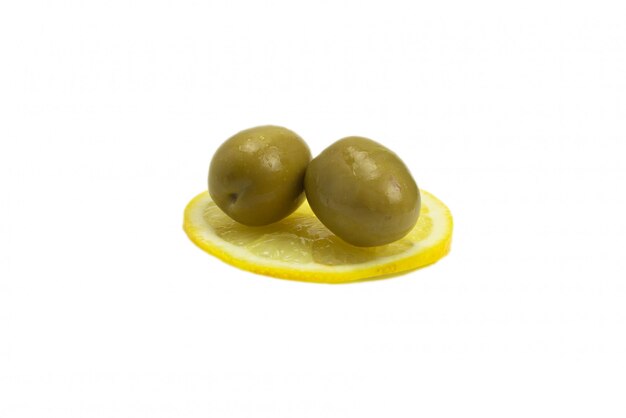 Two olives on a slice of lemon