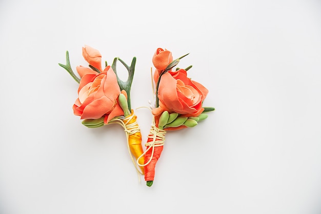 Two Orange Boutonniere on a white background