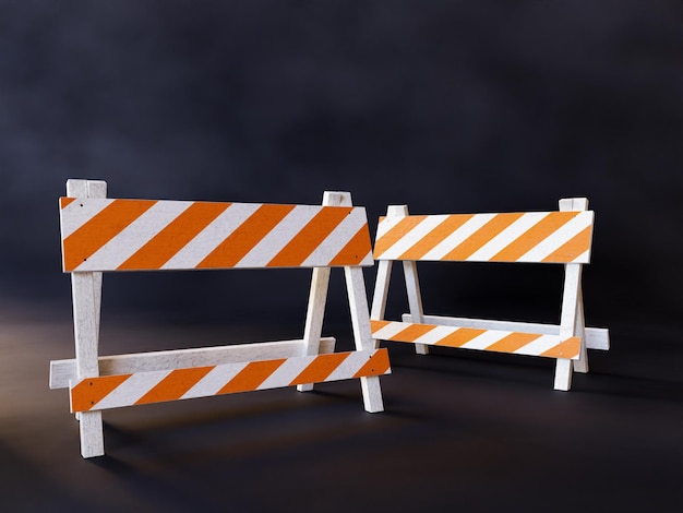 Photo two orange and white striped road construction barriers on dark background