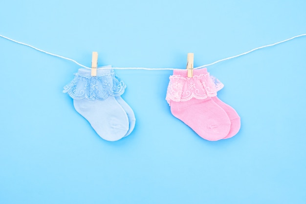 Photo two pair blue and pink cute baby socks on blue