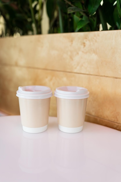 Two paper coffee cups in a cafe coffee to go concept Walks in the open air