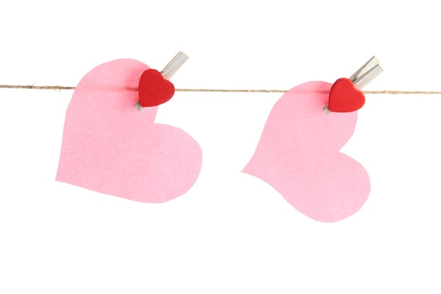 Two paper hearts on rope, isolated on white