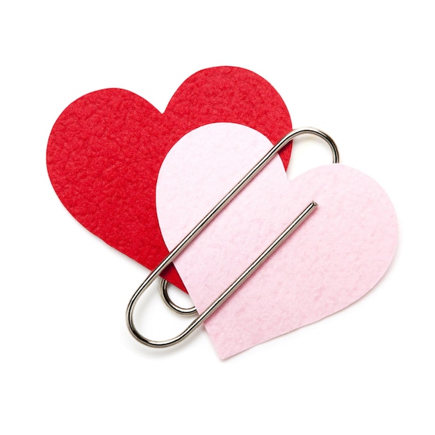 Two paper red hearts with paper Clip