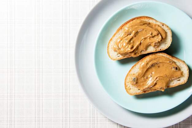 Two peanut butter sandwiches are on a blue plate.