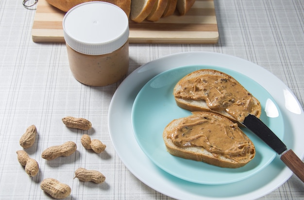 Two peanut butter sandwiches. Two slices of bread with peanut butter.