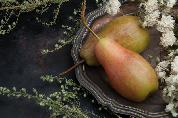 Two pears on black background