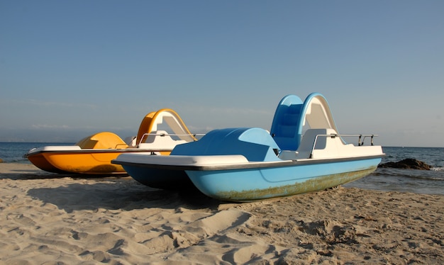 Two pedalos on a beach