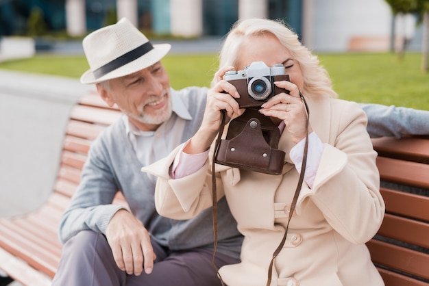 2人の年金受給者が古いフィルムカメラで写真を撮る