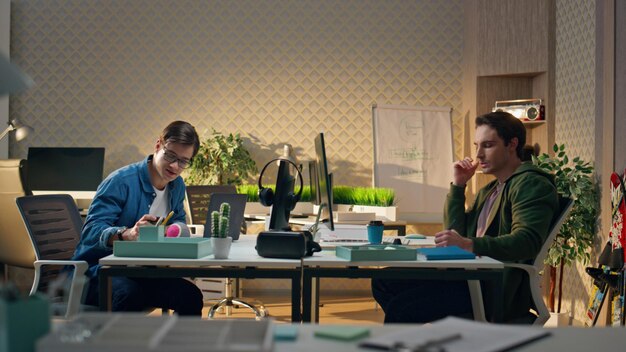 Two people communicating workplace interior positive man drinking tea at office