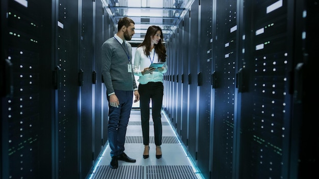 Two people in a data center with a server in the background