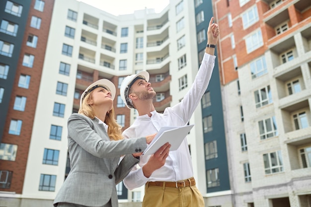 Two people examining a new construction object