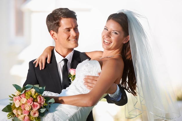 Two people happier would be impossible to find Two newlyweds celebrating their marriage outdoors