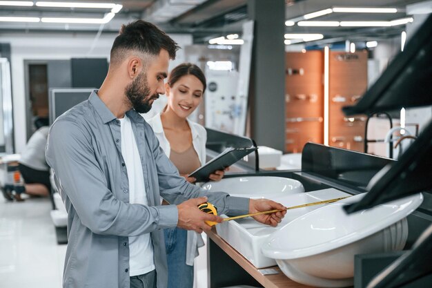 Two people is in the store of goods for the home