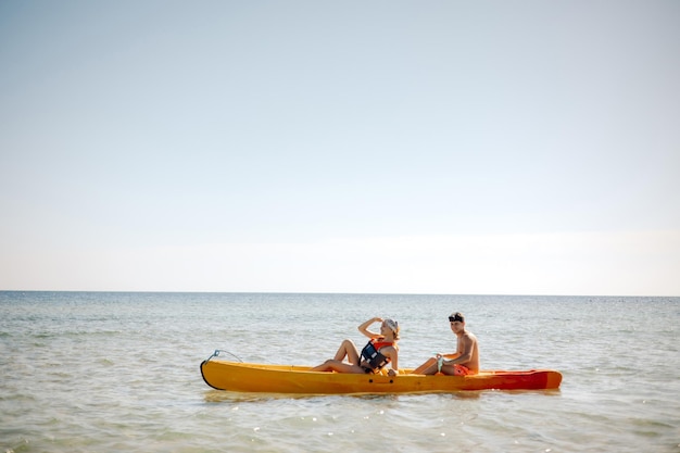 Two people in a kayak on the beach