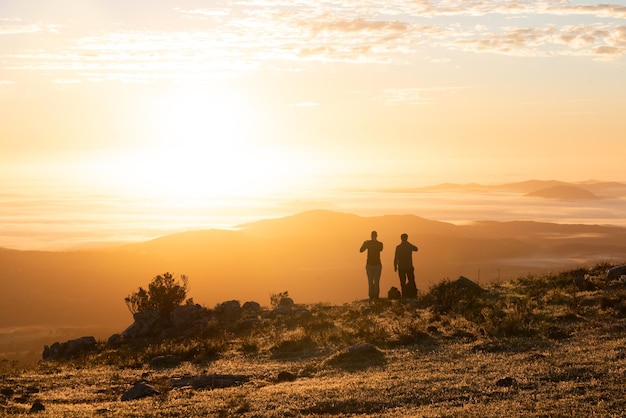 two people looking at golden sunrise