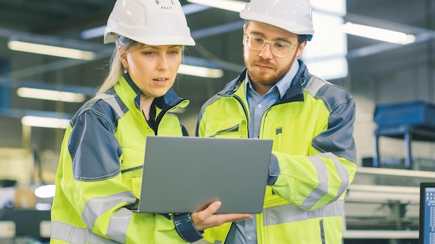 Two people looking at a laptop