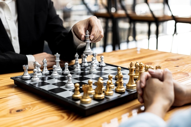 Two people playing a game of chess, concept image of two businessmen playing chess compared to a business competition that requires strategic planning and risk-based business management.