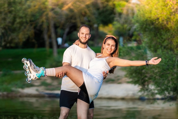 Two people posing in equilibrium using inline skates in a park