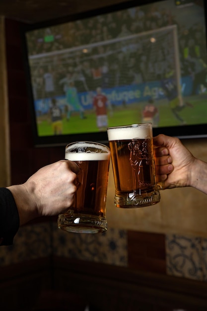 Two people toasting with a beer mug