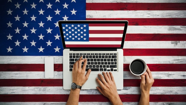 two people using a laptop with the american flag on the background