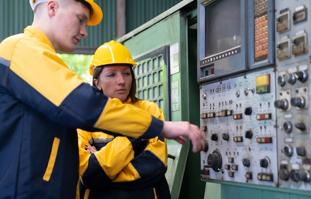 Two people working on a machine