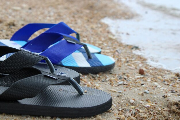 Two peoples slippers on a beautiful sandy beach chonburi thailand