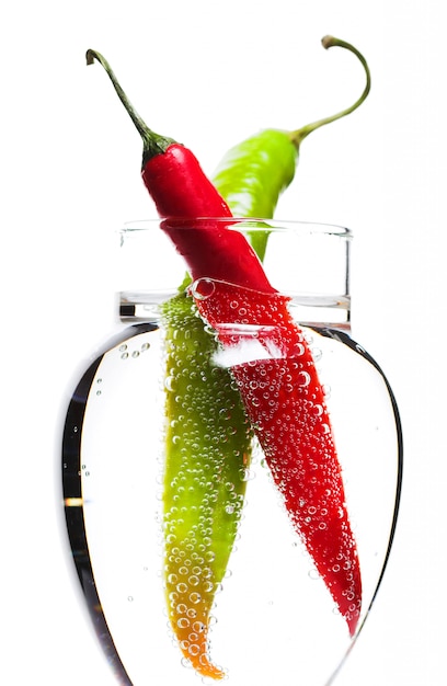 Two Peppers in The Glass of Bubbled Water.