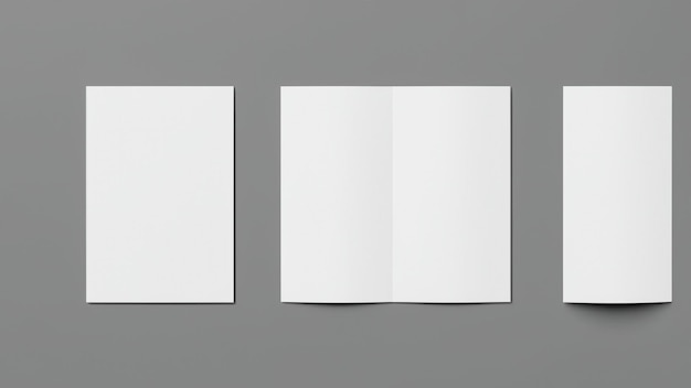 Photo two pieces of paper with one being folded on a gray background.