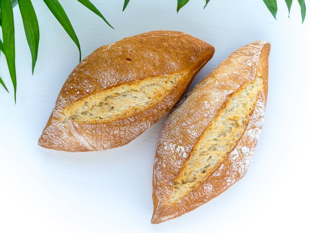 Two pieces of rustic bread with flour