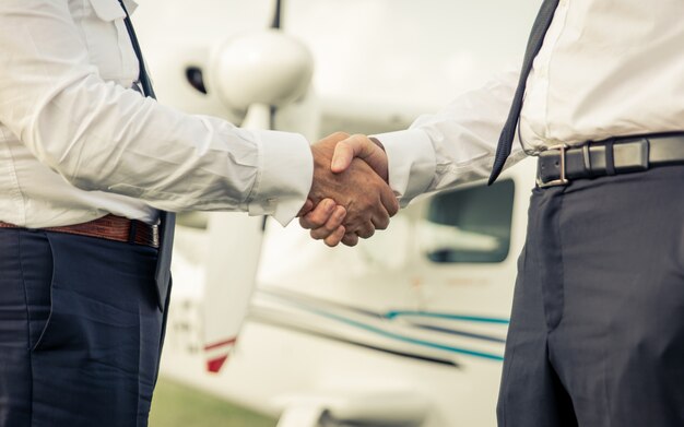 Two pilots shaking hands before flight