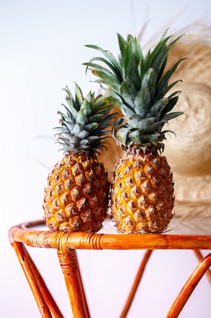 Two pineapples on a glass table